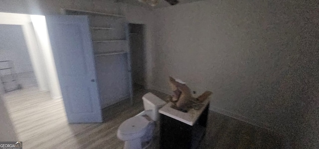 bathroom featuring wood-type flooring and toilet