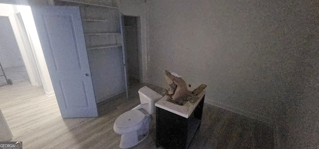 bathroom featuring hardwood / wood-style flooring and toilet