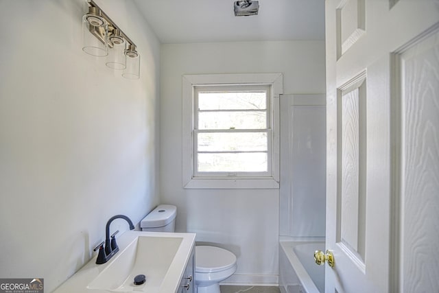 bathroom featuring vanity, toilet, and a bathtub