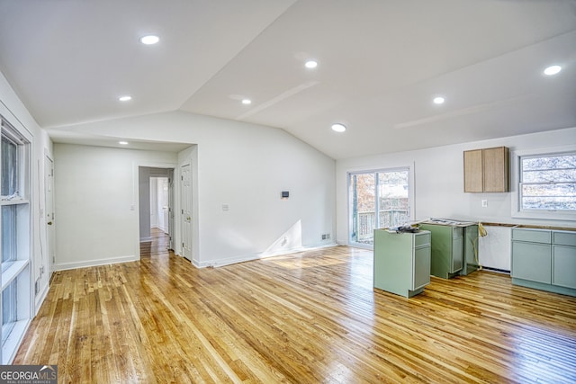 kitchen featuring light wood-type flooring, green cabinetry, and lofted ceiling