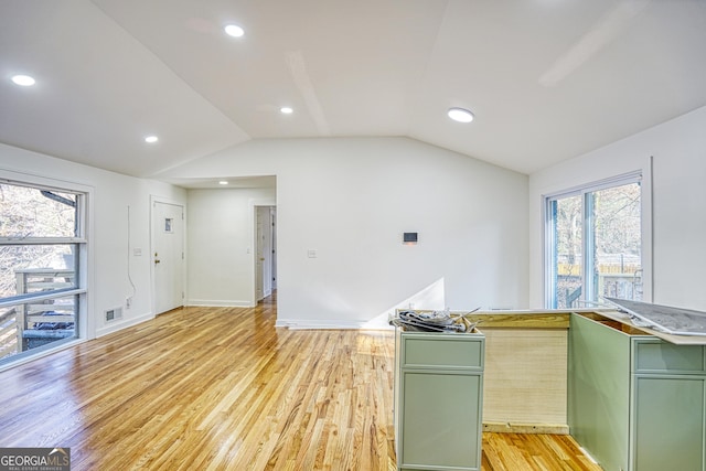 kitchen featuring light hardwood / wood-style flooring, vaulted ceiling, and green cabinetry