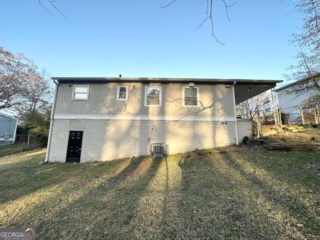 view of home's exterior featuring central air condition unit and a yard