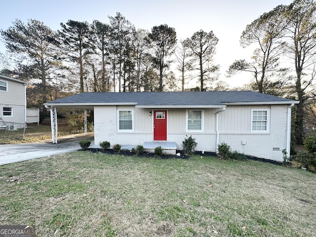 view of front facade with a carport and a front lawn