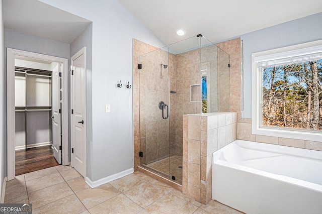 bathroom featuring tile patterned flooring, lofted ceiling, and independent shower and bath