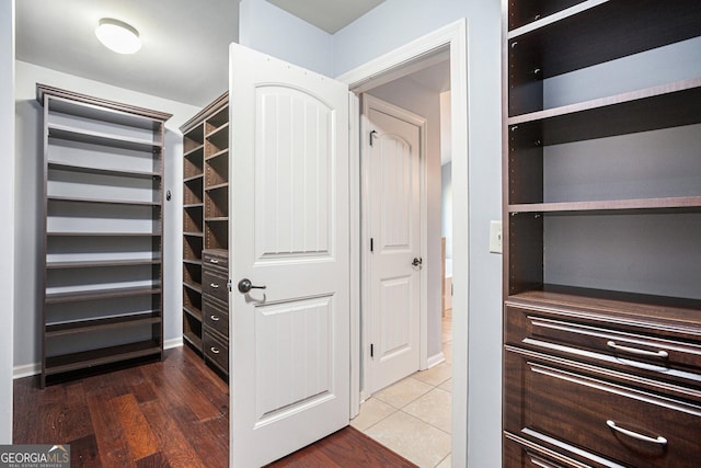 walk in closet with tile patterned floors