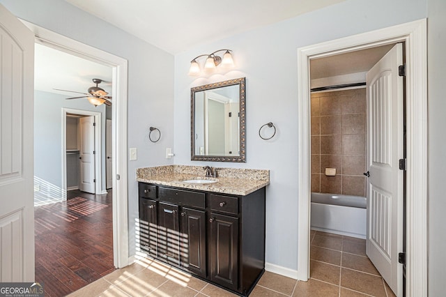 bathroom with tile patterned floors, vanity, and ceiling fan