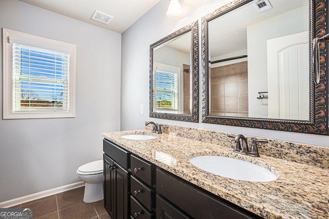 bathroom featuring tile patterned flooring, vanity, and toilet