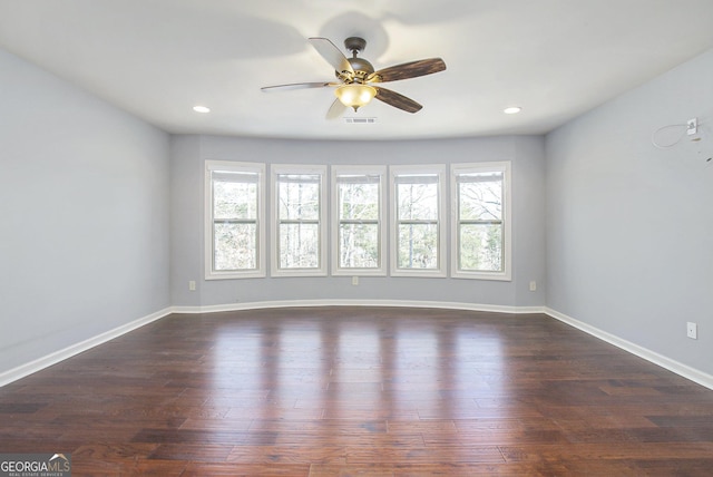 unfurnished room with dark hardwood / wood-style flooring, plenty of natural light, and ceiling fan