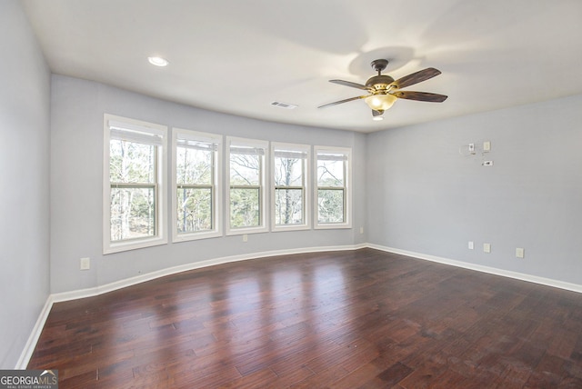 empty room with dark hardwood / wood-style flooring and ceiling fan