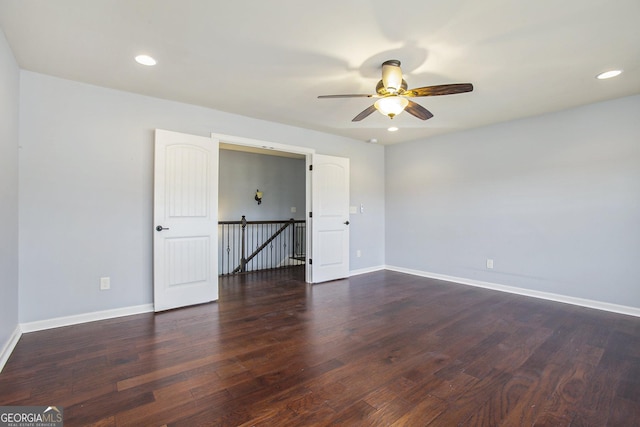 empty room featuring ceiling fan and dark hardwood / wood-style floors