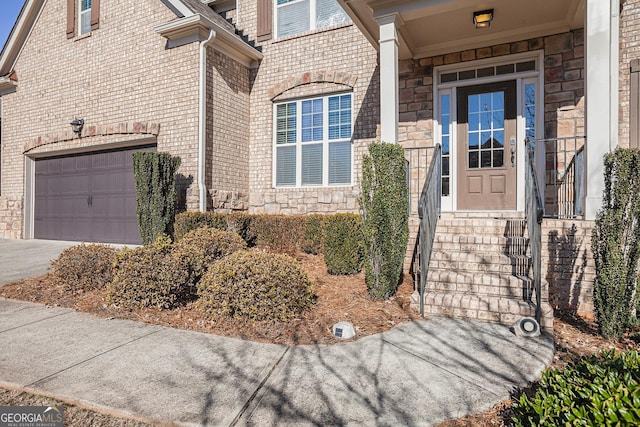 doorway to property with a garage