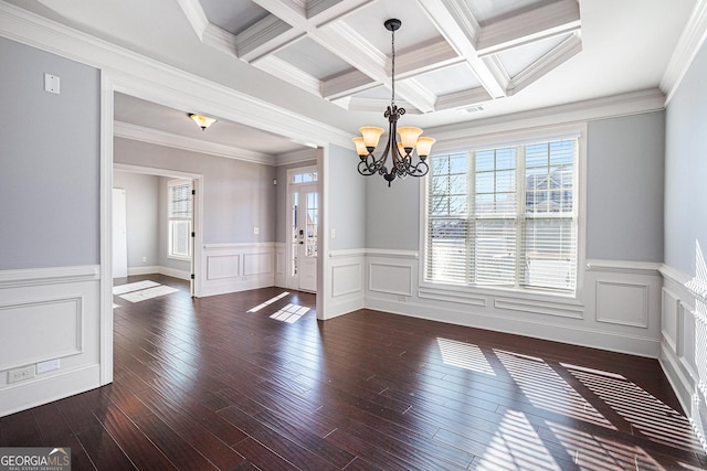 interior space featuring ornamental molding, coffered ceiling, beamed ceiling, a chandelier, and dark hardwood / wood-style floors