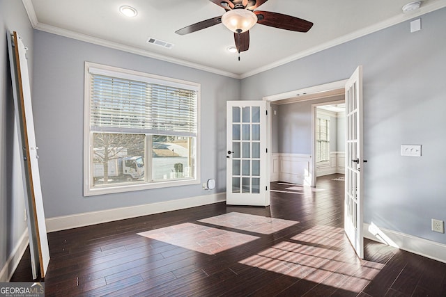 empty room featuring ceiling fan, dark hardwood / wood-style flooring, crown molding, and french doors