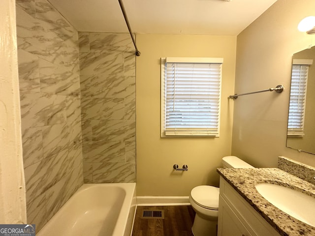 full bathroom with toilet, vanity, tiled shower / bath combo, and hardwood / wood-style flooring