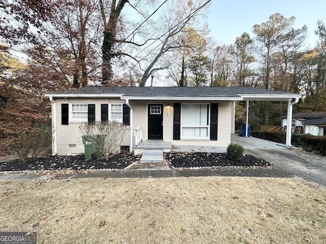 view of front facade with a front yard and a carport