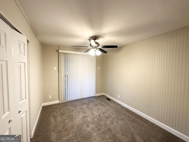 empty room with carpet flooring and ceiling fan