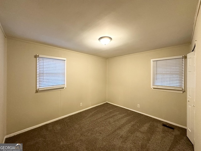 carpeted spare room featuring ornamental molding