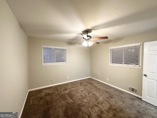 unfurnished room featuring ceiling fan and carpet