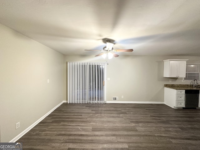 unfurnished living room with ceiling fan and dark hardwood / wood-style flooring