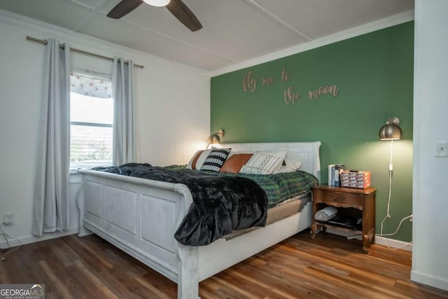 bedroom with ceiling fan, dark hardwood / wood-style floors, and crown molding