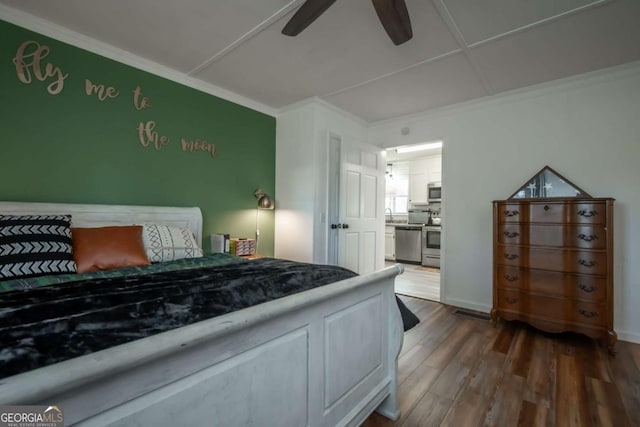 bedroom featuring ceiling fan, ornamental molding, and dark wood-type flooring