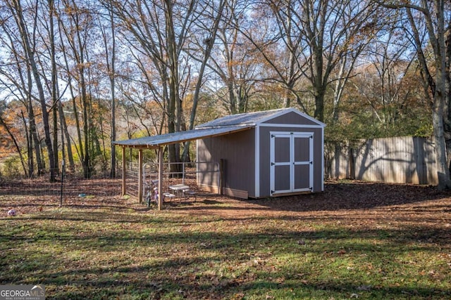 view of outbuilding featuring a lawn