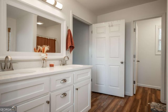 bathroom with vanity and wood-type flooring