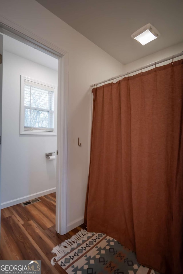 bathroom with hardwood / wood-style flooring