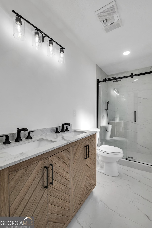 bathroom featuring an enclosed shower, vanity, and toilet