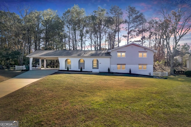 view of front facade featuring a yard and a carport