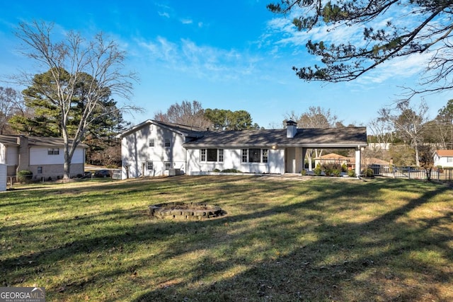 rear view of house featuring a yard