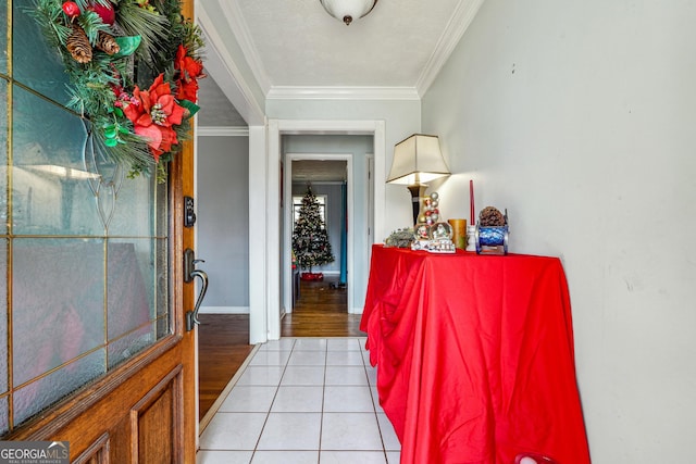 entryway with light wood-type flooring and crown molding