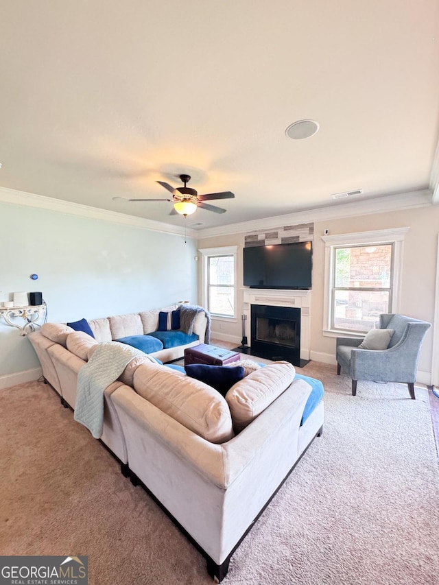 living room featuring ceiling fan, ornamental molding, and carpet flooring