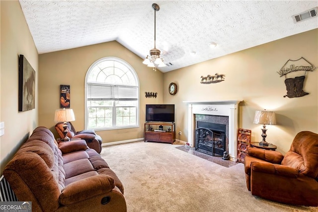 carpeted living room featuring a textured ceiling, ceiling fan, and lofted ceiling