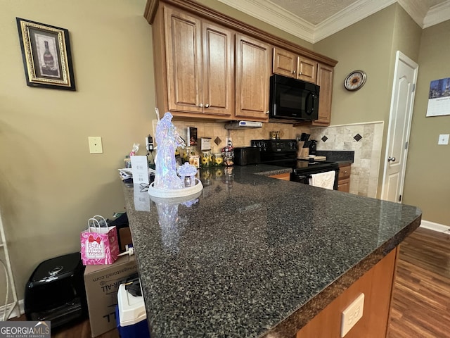 kitchen with decorative backsplash, kitchen peninsula, ornamental molding, dark wood-type flooring, and black appliances