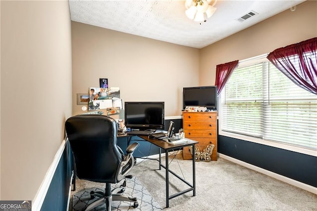 office space with carpet flooring, a textured ceiling, and ceiling fan