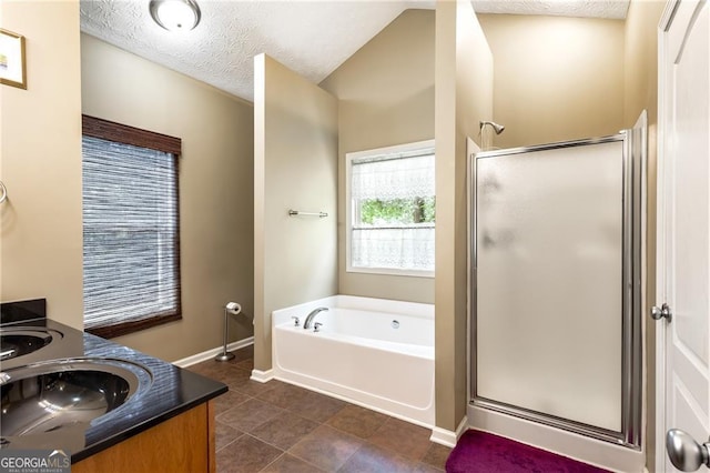 bathroom featuring tile patterned floors, vanity, independent shower and bath, and a textured ceiling