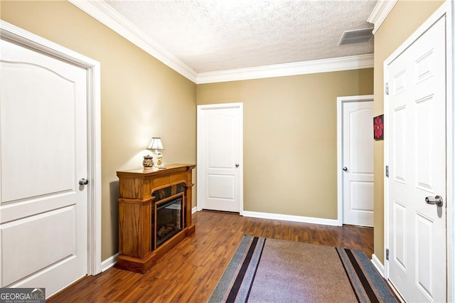 interior space with crown molding, dark wood-type flooring, and a textured ceiling