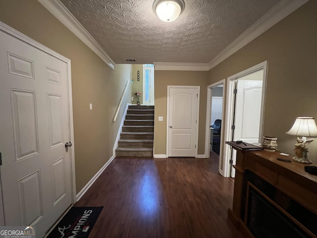 hall with dark hardwood / wood-style flooring, a textured ceiling, and crown molding