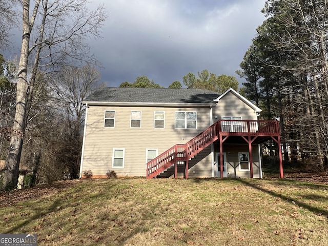 rear view of property featuring a lawn and a wooden deck