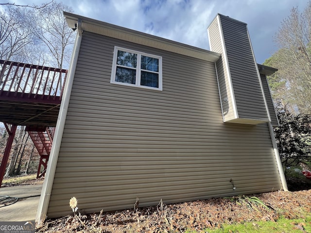 view of home's exterior featuring a wooden deck