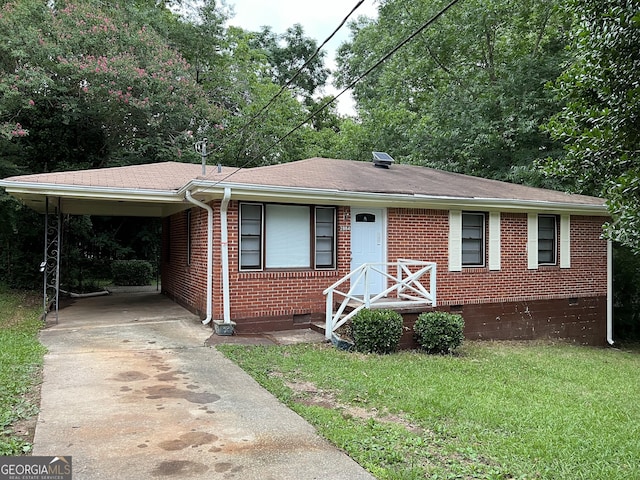 view of front of property with a carport and a front lawn