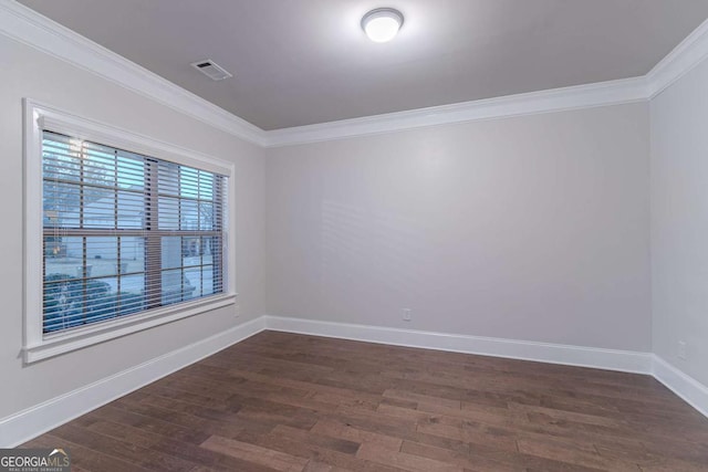 spare room with dark hardwood / wood-style flooring and crown molding