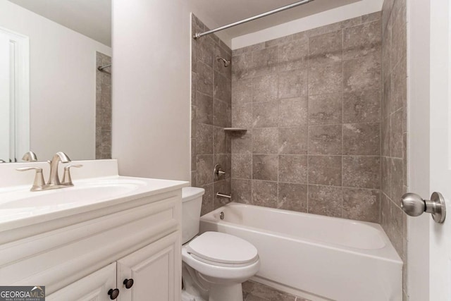 full bathroom featuring toilet, vanity, and tiled shower / bath