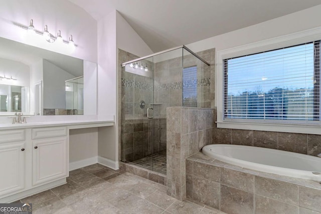 bathroom with separate shower and tub, vanity, and vaulted ceiling