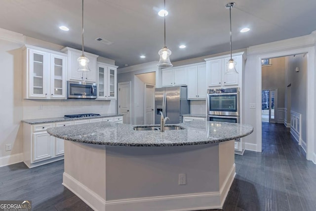 kitchen featuring appliances with stainless steel finishes, backsplash, white cabinets, dark hardwood / wood-style floors, and hanging light fixtures