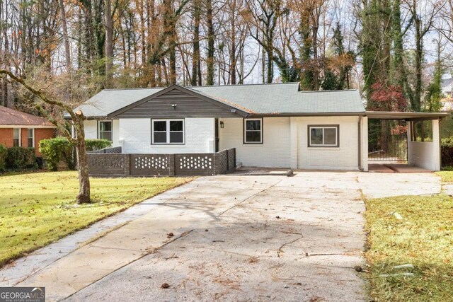 ranch-style house with a front lawn and a carport