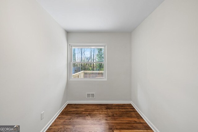 spare room featuring dark hardwood / wood-style flooring