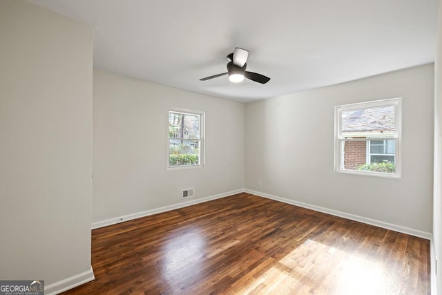 empty room featuring dark hardwood / wood-style floors and ceiling fan