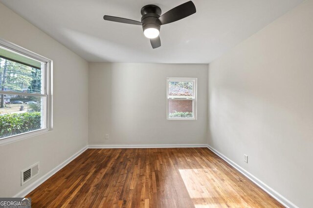 unfurnished room with hardwood / wood-style floors, plenty of natural light, and ceiling fan